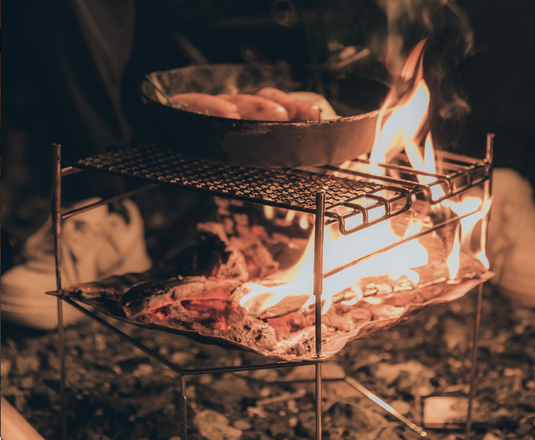 Durable camping cookware set arranged neatly on a portable table.